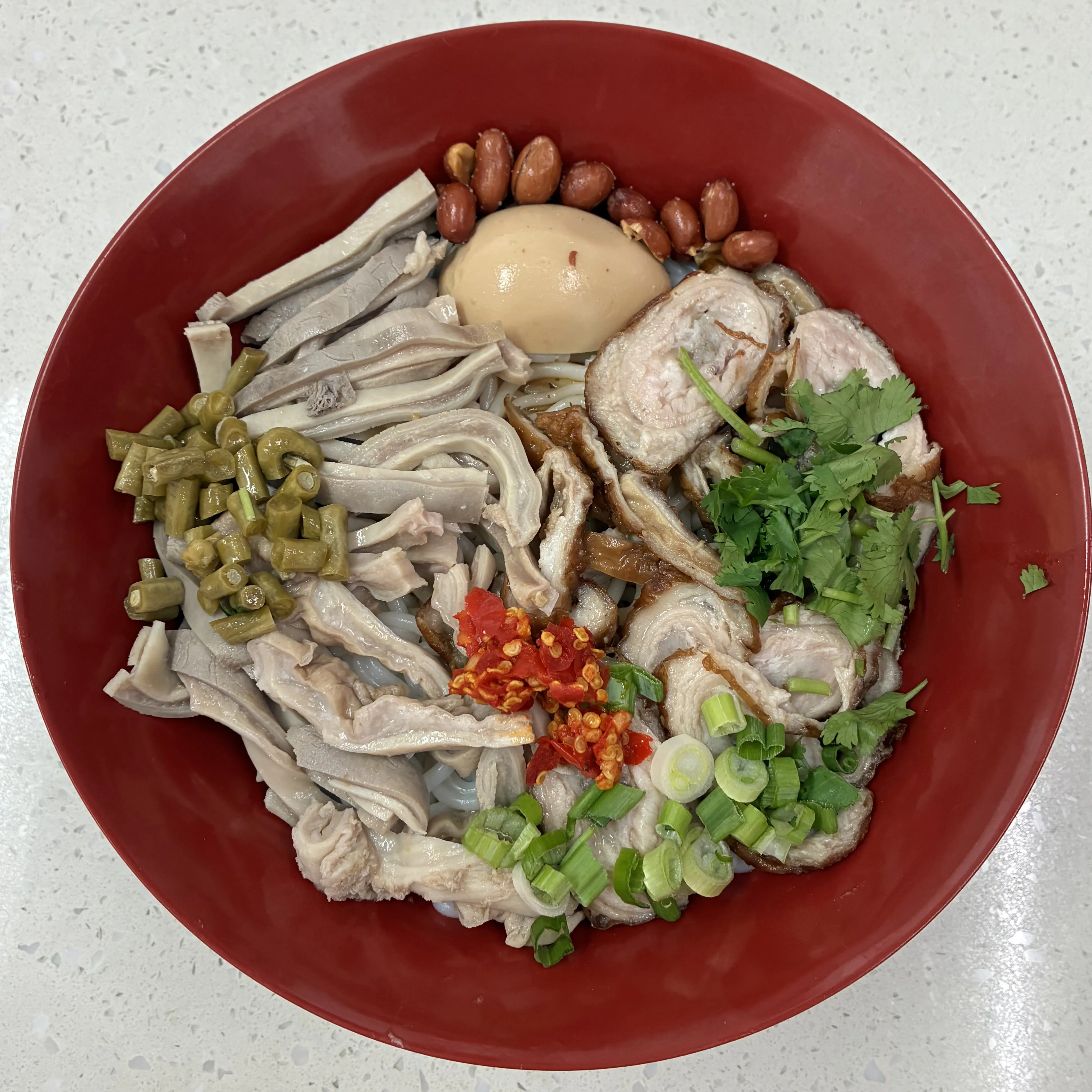 Dry rice noodles with pork tripe, roasted pork and chili toppings at Impression Guilin Noodle, a Chinese Noodle Restaurant in Monterey Park